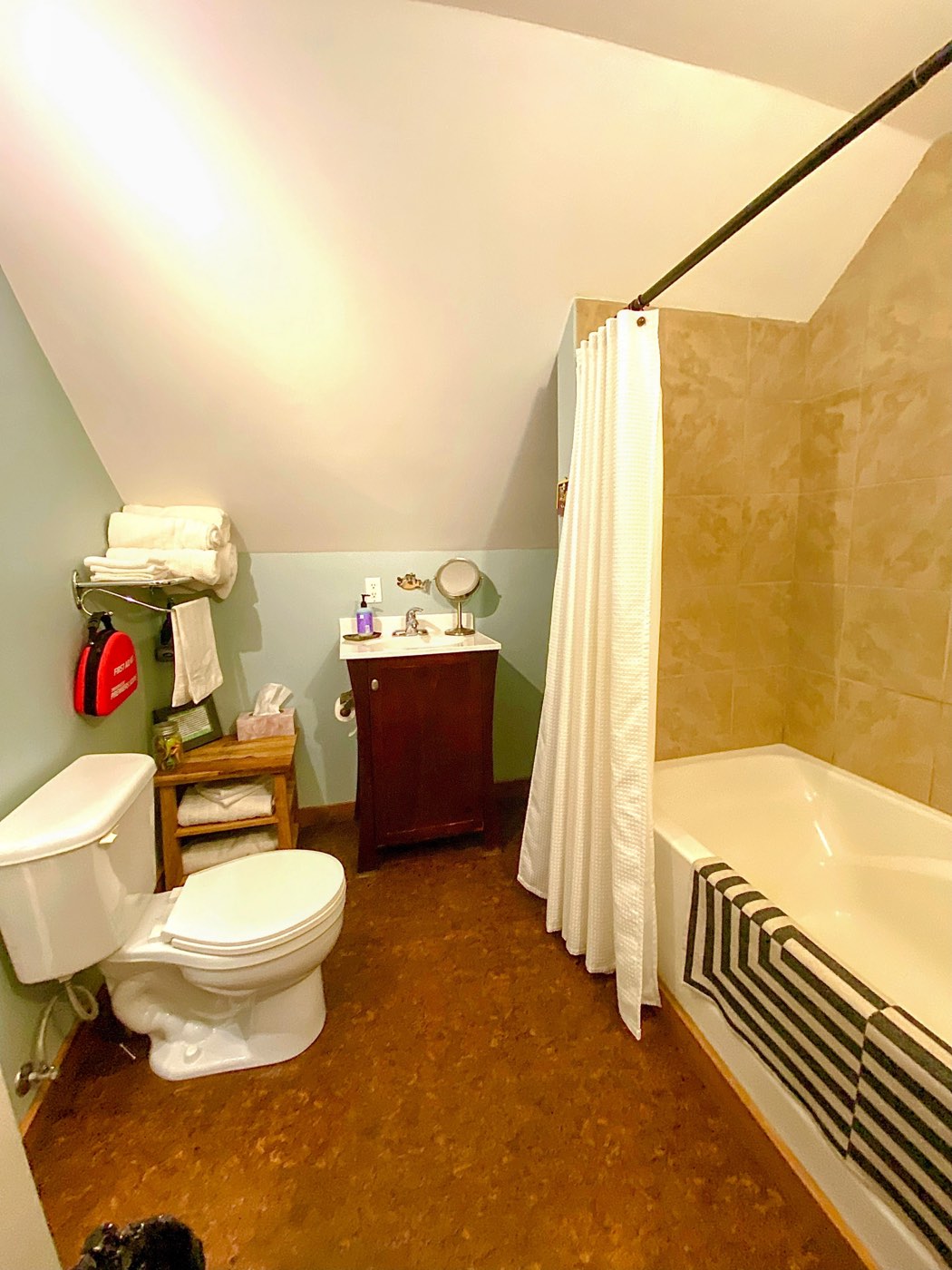The bathroom with a full tub, shower and vanity