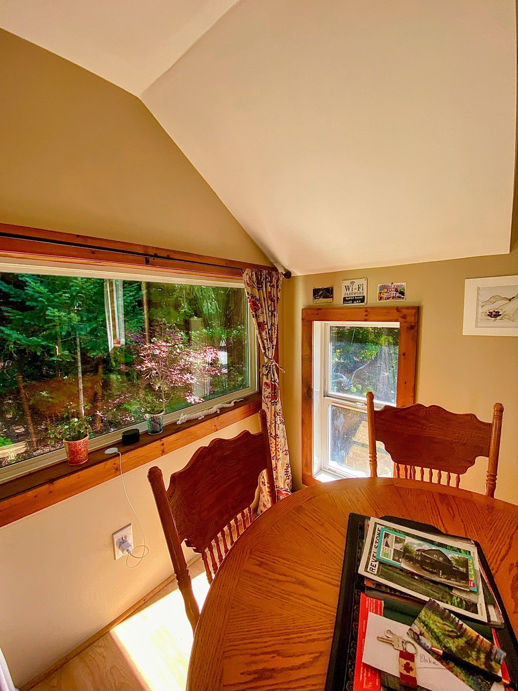 The dining table under the window with the garden outside