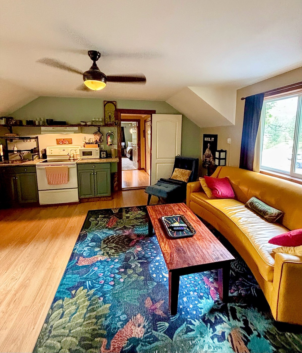 The living area with the kitchen and hallway beyond